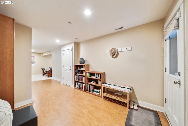 living area featuring recessed lighting, visible vents, and baseboards