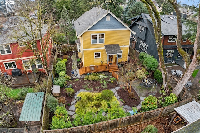 back of house featuring a wooden deck, a residential view, and a fenced backyard