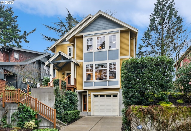 view of front of home with stairway, a garage, and driveway