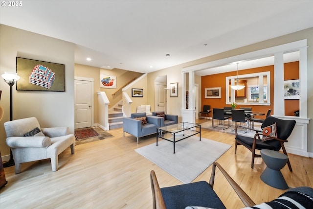 living area with stairway, recessed lighting, and light wood-style floors