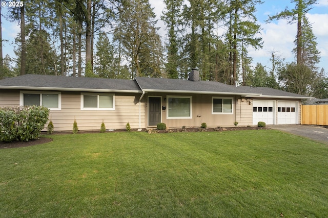 single story home with a garage and a front lawn