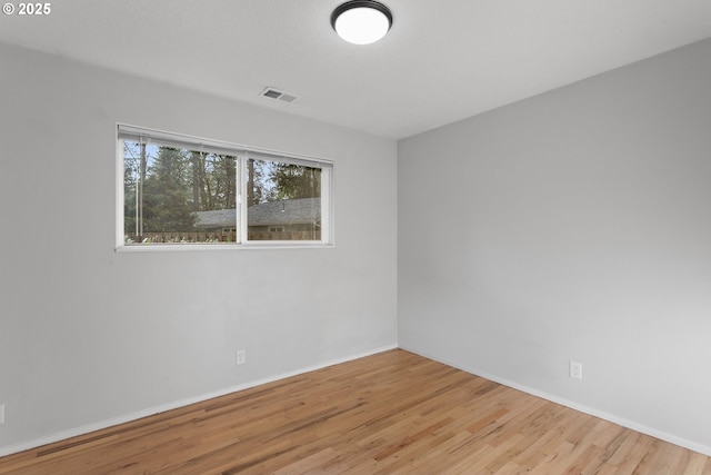 spare room with light wood-type flooring