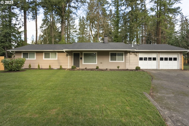 single story home with a garage and a front lawn