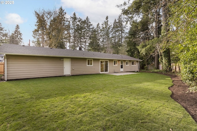 back of property featuring a patio area and a lawn