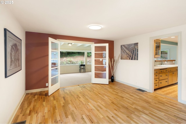54 W 31st Ave, Eugene, OR 97405 - empty room featuring french doors and light wood-style flooring