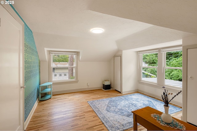 54 W 31st Ave, Eugene, OR 97405 - additional living space with vaulted ceiling, light wood-style floors, and a textured ceiling