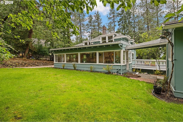 54 W 31st Ave, Eugene, OR 97405 - rear view of property featuring a sunroom, a chimney, and a lawn