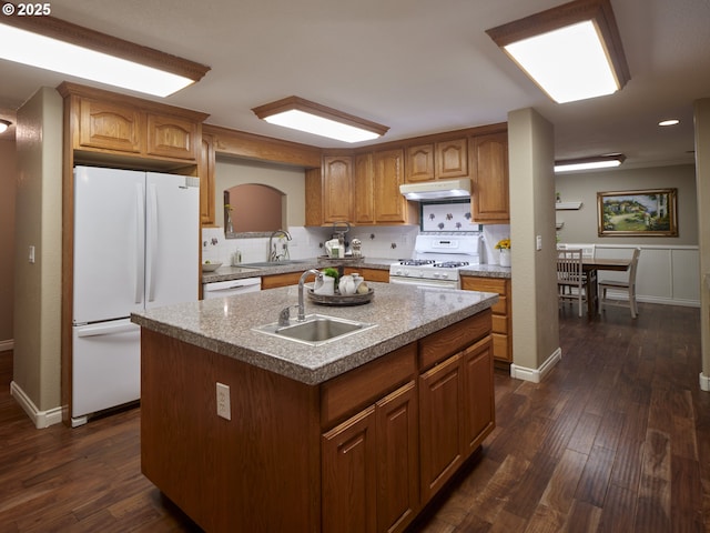2605 NE 189th St, Ridgefield, WA 98642 - kitchen featuring white appliances, decorative backsplash, dark wood-style floors, under cabinet range hood, and a sink