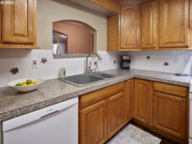2605 NE 189th St, Ridgefield, WA 98642 - kitchen with white dishwasher, decorative backsplash, brown cabinetry, and a sink