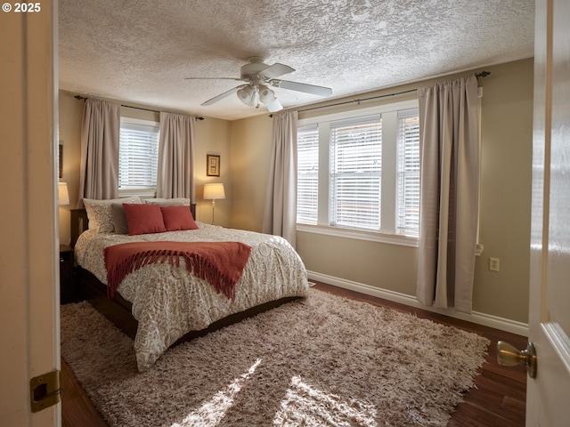 2605 NE 189th St, Ridgefield, WA 98642 - bedroom featuring ceiling fan, a textured ceiling, baseboards, and wood finished floors