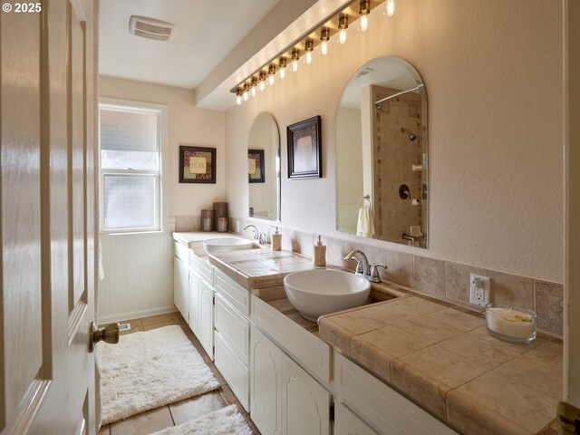 2605 NE 189th St, Ridgefield, WA 98642 - full bath with tile patterned flooring, visible vents, a sink, and double vanity