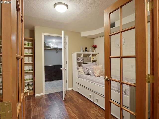 2605 NE 189th St, Ridgefield, WA 98642 - bedroom with a textured ceiling, dark wood-style flooring, and baseboards