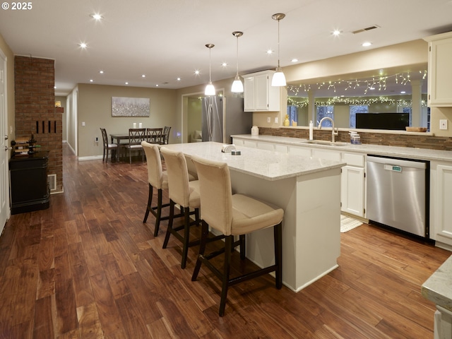 2605 NE 189th St, Ridgefield, WA 98642 - kitchen with dark wood-style floors, visible vents, appliances with stainless steel finishes, white cabinetry, and a sink
