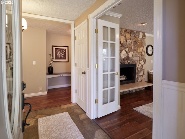 2605 NE 189th St, Ridgefield, WA 98642 - hallway with french doors, crown molding, a textured ceiling, and wood finished floors