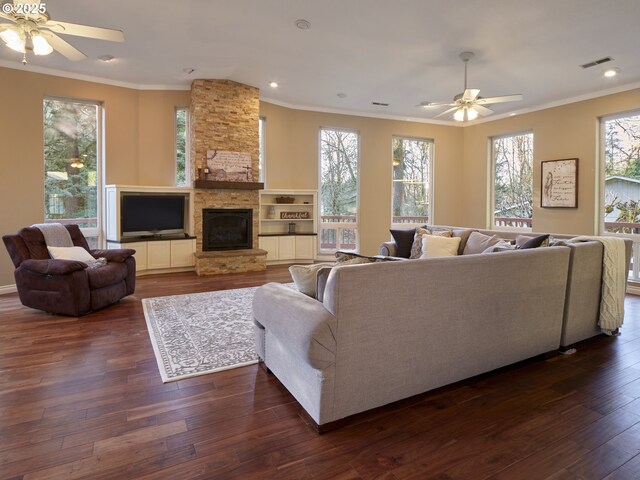 2605 NE 189th St, Ridgefield, WA 98642 - living room featuring a stone fireplace, ornamental molding, dark wood-style flooring, and visible vents