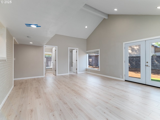 11421 SE Pardee St, Portland, OR 97266 - unfurnished living room featuring beam ceiling, french doors, light wood finished floors, high vaulted ceiling, and baseboards