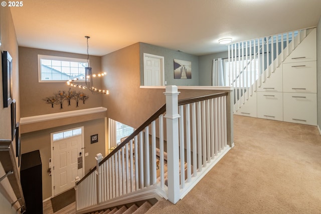 interior space featuring an inviting chandelier and carpet flooring