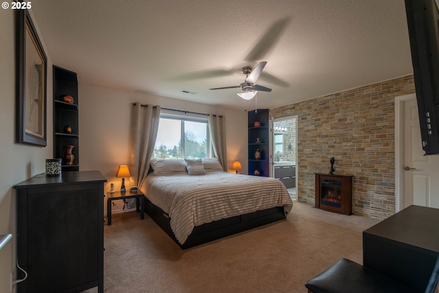 bedroom featuring ceiling fan, a textured ceiling, and light carpet