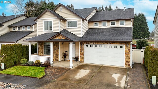 view of front of house featuring covered porch and a garage