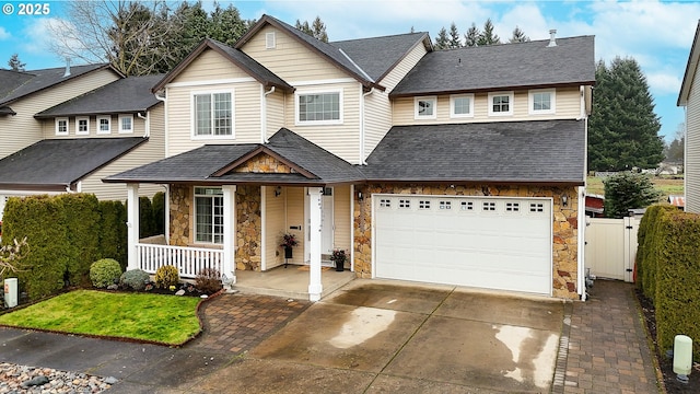 view of front of house featuring a porch and a garage