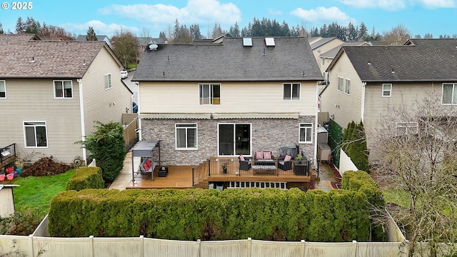 rear view of property featuring a wooden deck