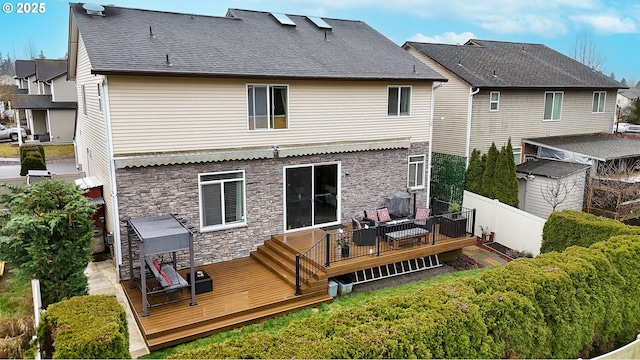 back of house featuring a wooden deck