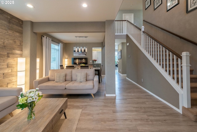 living room featuring light hardwood / wood-style floors and a notable chandelier