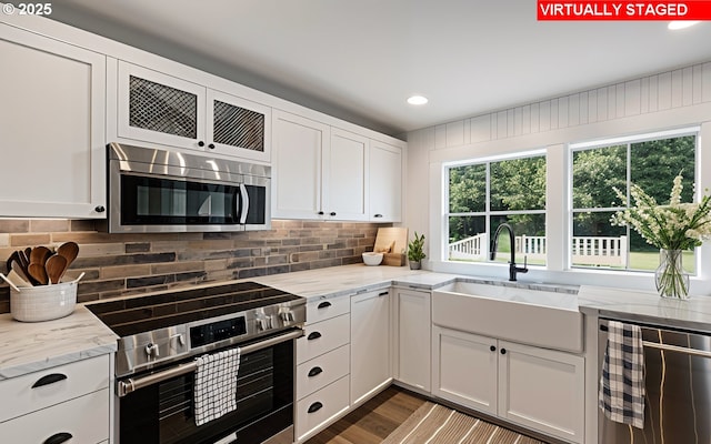 14023 Hawks Beard Unit Gm164, Black Butte Ranch, OR 97759 - kitchen featuring appliances with stainless steel finishes, a sink, white cabinetry, backsplash, and recessed lighting