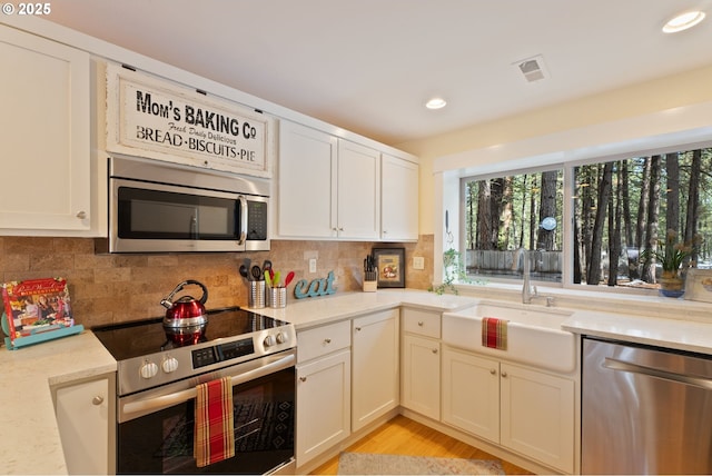 14023 Hawks Beard Unit Gm164, Black Butte Ranch, OR 97759 - kitchen featuring appliances with stainless steel finishes, a sink, backsplash, recessed lighting, and white cabinets