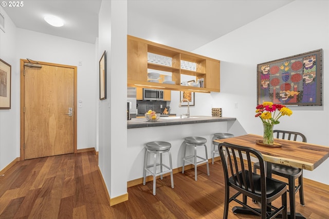 725 NW 10th Ave Unit 303, Portland, OR 97209 - dining room featuring baseboards and wood finished floors