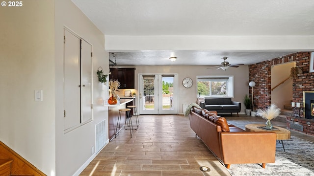 1060 SW 7th St, Hermiston, OR 97838 - living room featuring light wood-style floors, a fireplace, and a ceiling fan