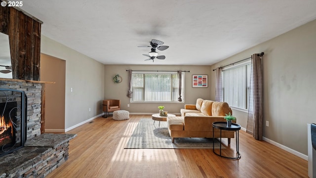 1060 SW 7th St, Hermiston, OR 97838 - living room with ceiling fan, light wood finished floors, a fireplace, and baseboards