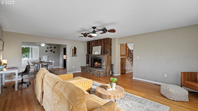 1060 SW 7th St, Hermiston, OR 97838 - living room featuring a ceiling fan, a stone fireplace, and wood finished floors