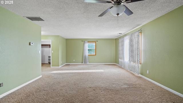 1060 SW 7th St, Hermiston, OR 97838 - unfurnished room with carpet floors, ceiling fan, baseboards, and a textured ceiling