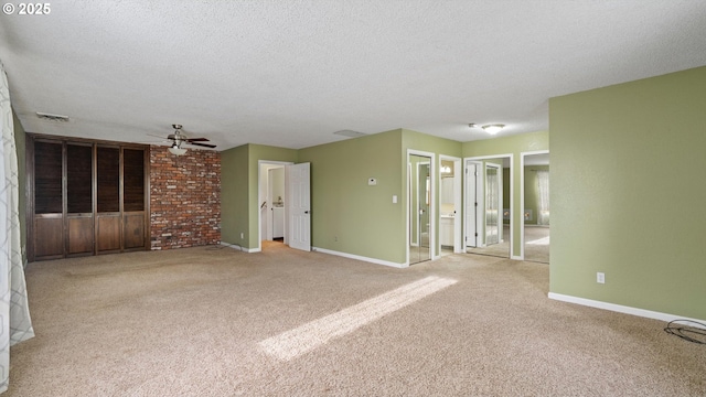 1060 SW 7th St, Hermiston, OR 97838 - unfurnished living room with ceiling fan, light colored carpet, a textured ceiling, and baseboards