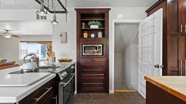1060 SW 7th St, Hermiston, OR 97838 - kitchen with appliances with stainless steel finishes, a ceiling fan, dark brown cabinetry, a textured ceiling, and a peninsula