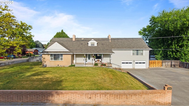 1060 SW 7th St, Hermiston, OR 97838 - view of front of house with a porch, concrete driveway, a garage, and a chimney