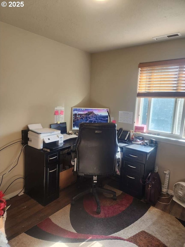 office space featuring wood finished floors and visible vents
