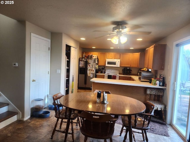 dining room featuring a ceiling fan, a toaster, baseboards, stairway, and recessed lighting