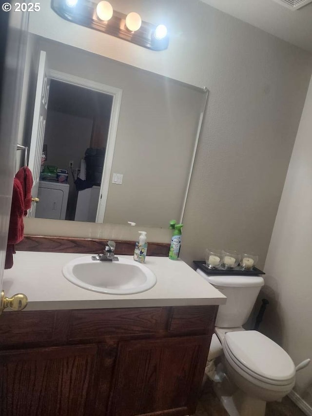 bathroom featuring vanity and toilet