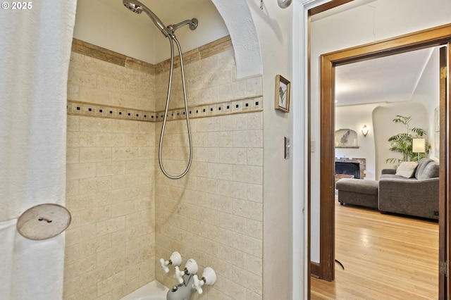 1710 SE 42nd Ave, Portland, OR 97215 - full bathroom with a fireplace, tub / shower combination, and wood finished floors
