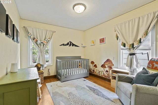 1710 SE 42nd Ave, Portland, OR 97215 - bedroom with light wood finished floors and a nursery area