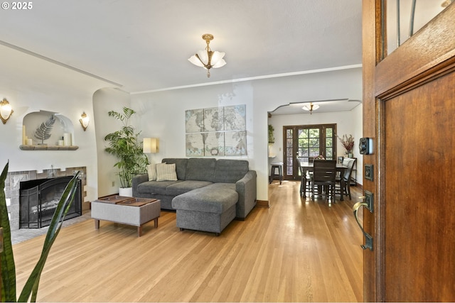 1710 SE 42nd Ave, Portland, OR 97215 - living room with arched walkways, a fireplace with flush hearth, light wood-style flooring, and crown molding
