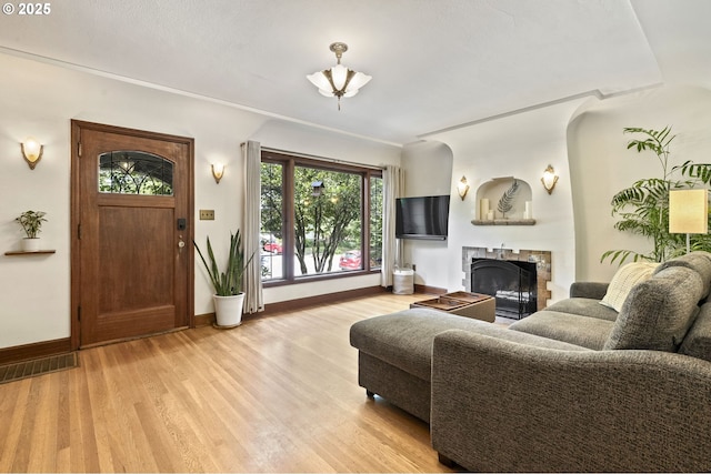 1710 SE 42nd Ave, Portland, OR 97215 - living area with a fireplace, light wood-style floors, and baseboards