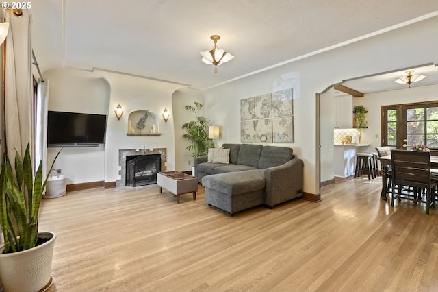 1710 SE 42nd Ave, Portland, OR 97215 - living room with light wood-style floors, a fireplace with flush hearth, and baseboards