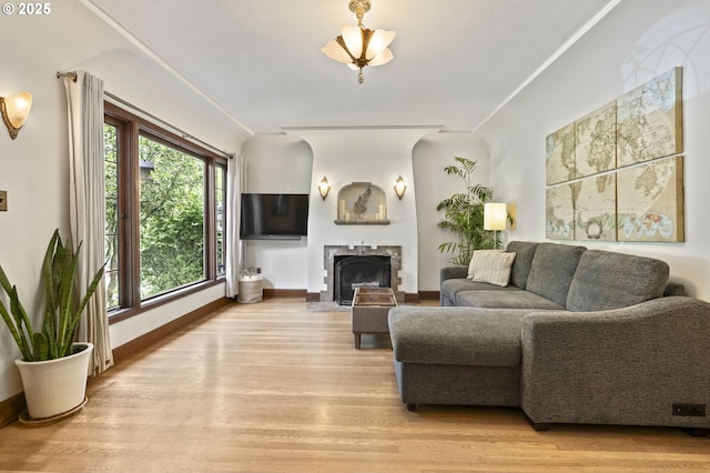 1710 SE 42nd Ave, Portland, OR 97215 - living room featuring light wood-style flooring, baseboards, and a fireplace with flush hearth