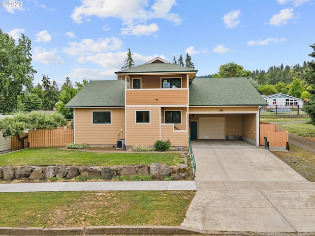 702 B Ave, La Grande, OR 97850 - traditional-style house featuring a garage, a front lawn, fence, a shingled roof, and concrete driveway