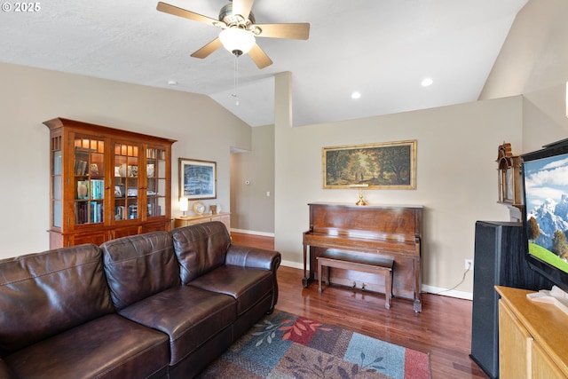 living area with lofted ceiling, ceiling fan, baseboards, and wood finished floors