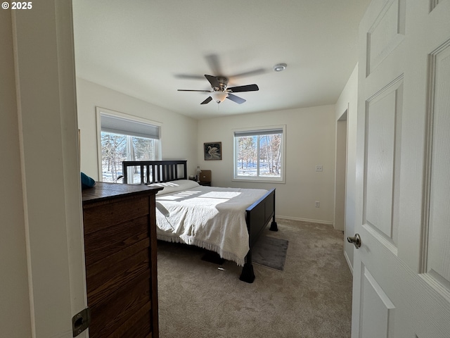 carpeted bedroom with ceiling fan and multiple windows