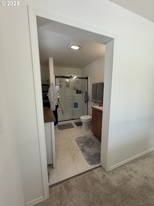 bathroom with vanity, an enclosed shower, and toilet